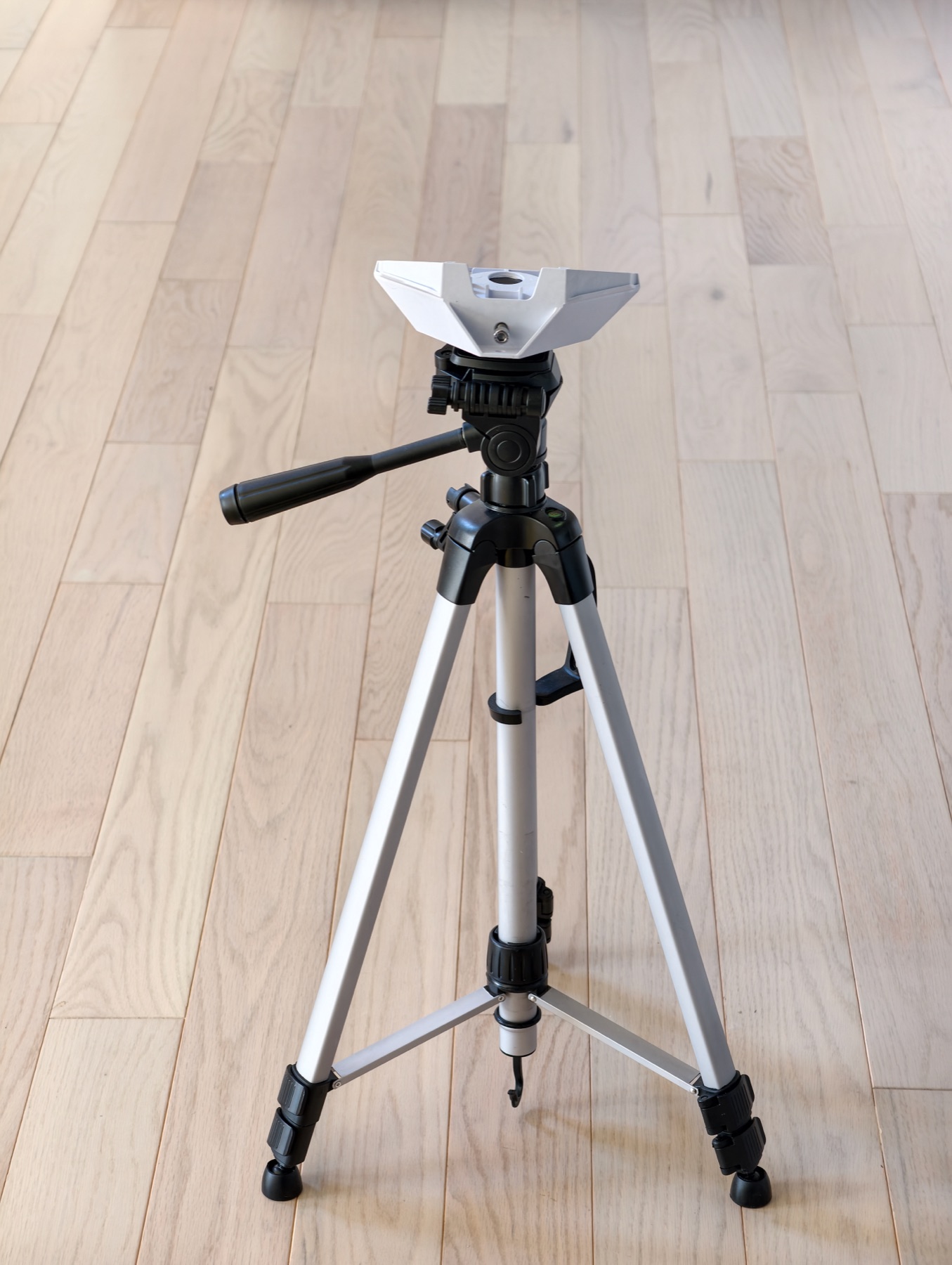 A Starlink Mini mount base installed on a portable tripod indoors for fit and stability testing.